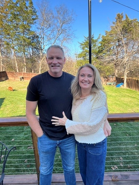 TrueStead Home Co. owners Mike and Michelle Van Metre smiling on their back deck